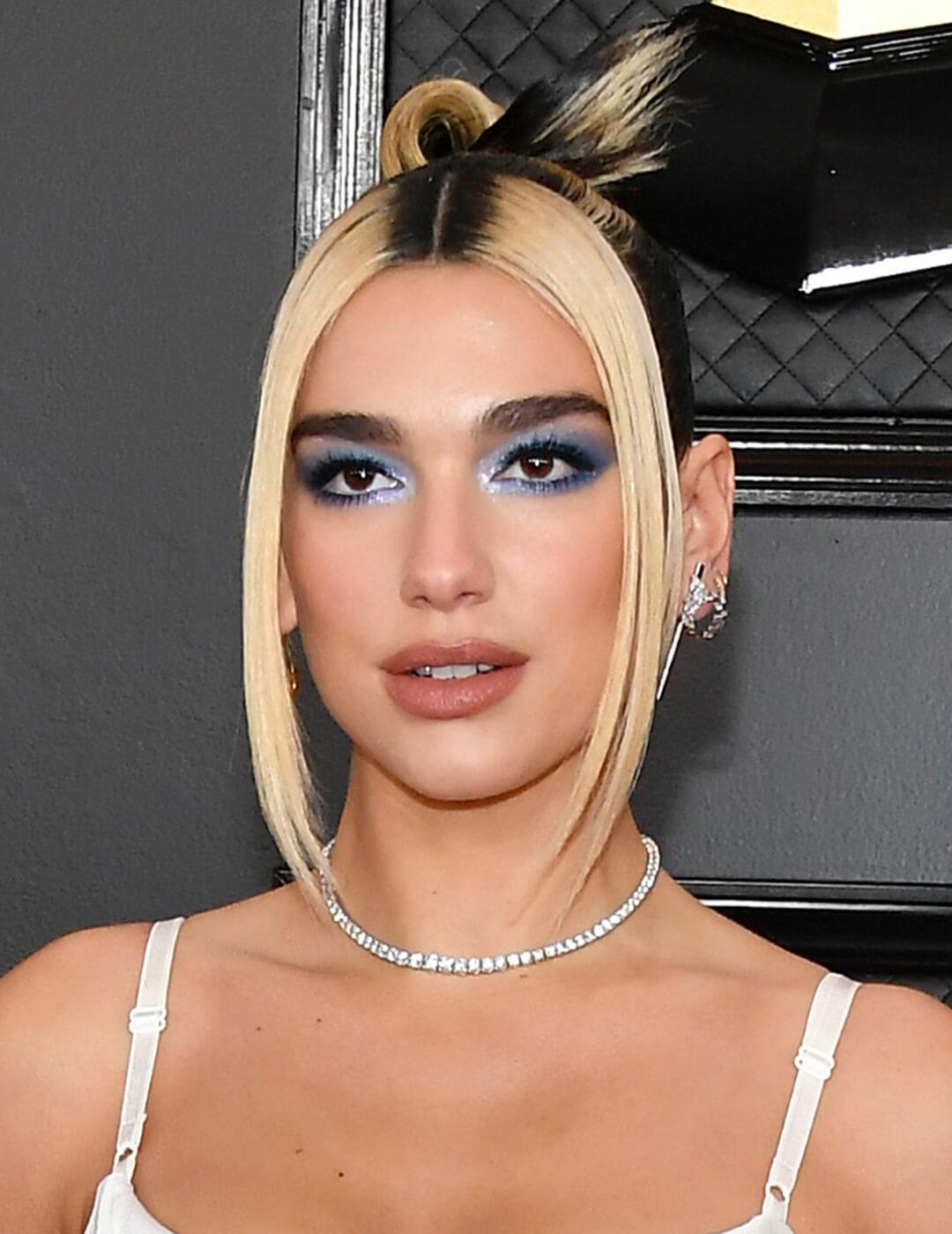 Dua Lipa rocking piecy, chunky highlights and metallic blue eyeshadow paired with nude lips Desktop
