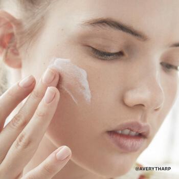A model slathers on a moisturizer to keep her skin hydrated.  Mobile