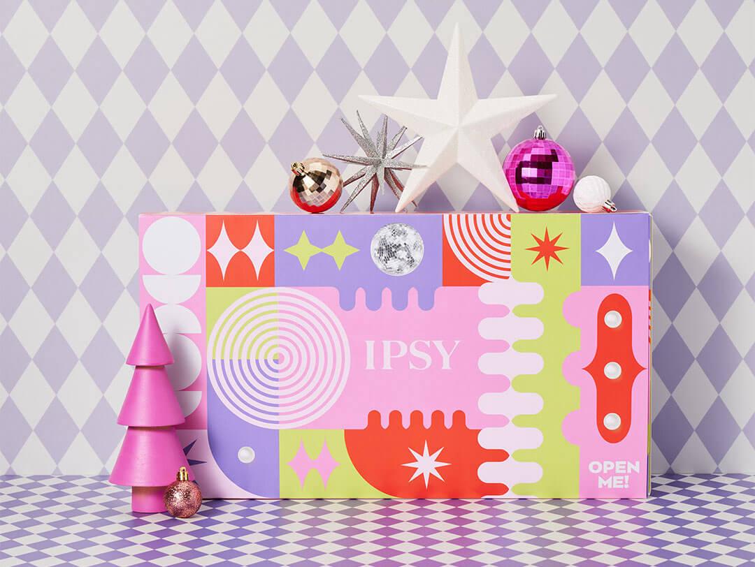 IPSY's 25-day advent calendar on a checkered background with holiday-themed decor around it. Desktop