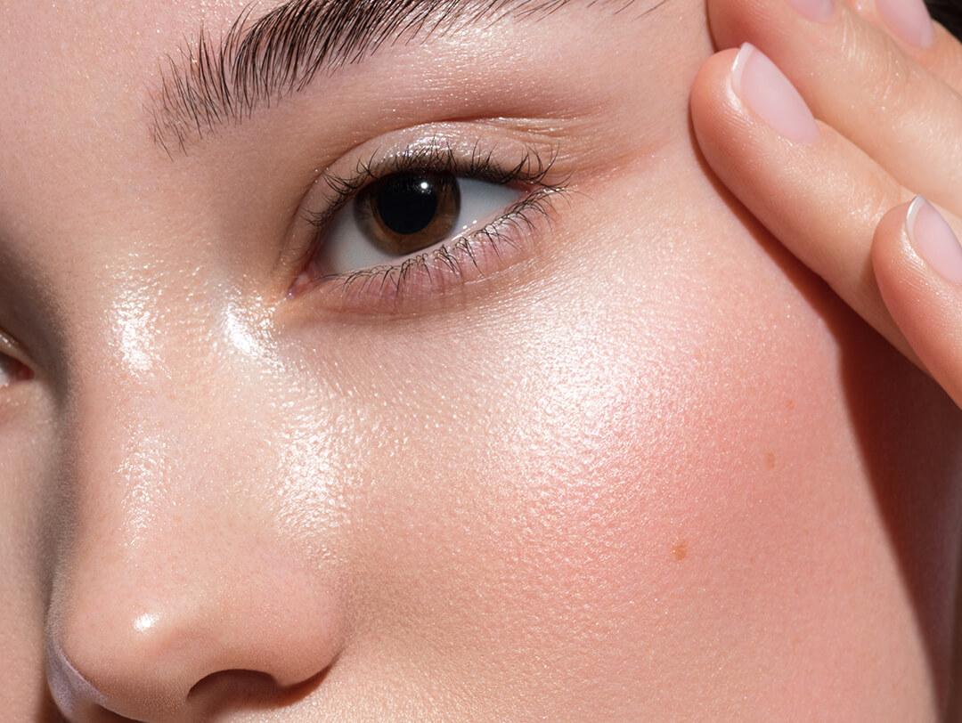 A closeup photo of a model face with beautiful glowy skin